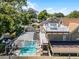 Aerial view of home showcasing rooftop deck, screened in pool, and mature trees at 910 Alameda St, Orlando, FL 32804