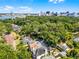 Stunning aerial view showcasing the home, lush greenery, and the city skyline in the distance at 910 Alameda St, Orlando, FL 32804