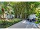 Secluded backyard featuring a shed, brick patio, palm trees, and lush bamboo for privacy at 910 Alameda St, Orlando, FL 32804