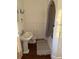 Charming bathroom featuring wainscoting, pedestal sink, and a tub/shower combination at 910 Alameda St, Orlando, FL 32804
