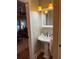 Elegant pedestal sink with vintage faucet and lighting, next to a living room at 910 Alameda St, Orlando, FL 32804