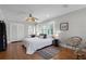 Bright bedroom with white plantation shutters, wood floors, and decorative ceiling fan at 910 Alameda St, Orlando, FL 32804