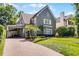 Charming two-story home with a well-manicured lawn and beautiful landscaping, plus convenient porte-cochere at 910 Alameda St, Orlando, FL 32804