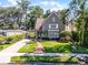 Charming two-story home featuring a manicured lawn and brick walkway leading to the front door at 910 Alameda St, Orlando, FL 32804