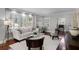 Bright living room featuring hardwood floors, white sofa, large windows with shutters, and decorative lighting at 910 Alameda St, Orlando, FL 32804