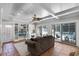 Spacious living room with a white coffered ceiling, built-in shelves, and sliding glass doors to the outdoor pool area at 910 Alameda St, Orlando, FL 32804