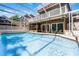 Gorgeous pool area, screened-in with an elevated balcony, and chairs for outdoor lounging at 910 Alameda St, Orlando, FL 32804