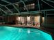 Stunning pool area, lit by night, featuring comfortable outdoor seating and a balcony at 910 Alameda St, Orlando, FL 32804