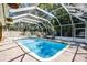 A beautiful pool area with a screen enclosure offers privacy and a refreshing escape at 910 Alameda St, Orlando, FL 32804