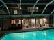 Inviting pool, lit by night, featuring comfortable outdoor seating and a balcony at 910 Alameda St, Orlando, FL 32804