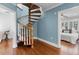 Unique spiral staircase with hardwood steps and white spindles, connecting the home's levels with style at 910 Alameda St, Orlando, FL 32804