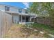 Backyard with a patio, privacy fence, and shade tree, offering an ideal outdoor space at 2652 Laser Ct, Orlando, FL 32826