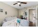 Cozy bedroom featuring a ceiling fan, closet with mirrored doors, and en-suite access at 2652 Laser Ct, Orlando, FL 32826