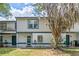 Charming townhome with covered entry, light siding, and tree in the front yard at 2652 Laser Ct, Orlando, FL 32826