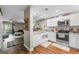 Contemporary kitchen boasting white cabinets, hardwood floors, and a breakfast bar at 2652 Laser Ct, Orlando, FL 32826