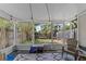 Screened-in patio with seating and views of the backyard, perfect for enjoying the outdoors at 2652 Laser Ct, Orlando, FL 32826