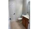 This half bathroom features tile flooring, toilet and vanity with an oak finish at 6327 Southbridge St, Windermere, FL 34786