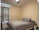 Cozy bedroom features a bed with grey striped bedding, and a side table at 6327 Southbridge St, Windermere, FL 34786