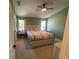 Well-lit bedroom features a neutral color scheme, plush carpeting, and ceiling fan at 6327 Southbridge St, Windermere, FL 34786