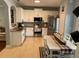 Bright kitchen with stainless steel appliances, white cabinets, and a dining table at 6327 Southbridge St, Windermere, FL 34786