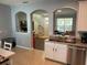 Open-concept kitchen view showcasing tiled flooring, stainless steel appliances, and seamless archway to the living room at 6327 Southbridge St, Windermere, FL 34786