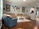 Comfortable living room featuring a large sectional sofa, accent rug, and unique wall decorations at 6327 Southbridge St, Windermere, FL 34786