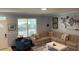 Comfortable living room with a sectional sofa, accent chair, and natural light at 6327 Southbridge St, Windermere, FL 34786