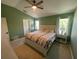 Cozy bedroom with natural light, ceiling fan, and stylish decor at 6327 Southbridge St, Windermere, FL 34786