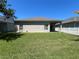 Spacious backyard with green lawn, privacy fence and a covered patio, perfect for outdoor activities at 14220 Morning Frost Dr, Orlando, FL 32828