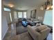Bright living room featuring neutral tones, comfortable couches, and large windows that let in natural light at 14220 Morning Frost Dr, Orlando, FL 32828