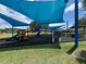 Community playground with slides, climbing structures, and shade canopies for outdoor fun at 14220 Morning Frost Dr, Orlando, FL 32828