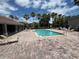 Inviting community pool with lounge chairs, surrounding deck, and a covered cabana area at 14220 Morning Frost Dr, Orlando, FL 32828