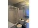 Modest bathroom featuring a shower with curtain, white tile, standard toilet, vanity and mirror at 1909 Lady Ave, Ocoee, FL 34761