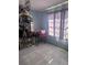 A cozy bedroom with a curio cabinet, tile floors and a window for natural light at 1909 Lady Ave, Ocoee, FL 34761