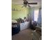 Cozy bedroom with a ceiling fan, bright green walls and a window for natural light at 1909 Lady Ave, Ocoee, FL 34761