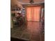 This is an image of a kitchen with tile flooring, a window, a light fixture, and orange drapes at 1909 Lady Ave, Ocoee, FL 34761