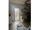 Functional laundry area with machines and shelving for storage, providing convenience and organization at 1909 Lady Ave, Ocoee, FL 34761