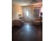 Cozy living room featuring hardwood floors, neutral paint, and comfortable seating with a ceiling fan at 1909 Lady Ave, Ocoee, FL 34761