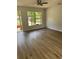 Bright living room featuring wood-look flooring and a large window for ample natural light at 1909 Lady Ave, Ocoee, FL 34761