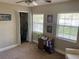 Bedroom featuring carpeted floors, a small closet, multiple windows and light-colored walls at 2141 Lake Margaret Dr # 11, Orlando, FL 32806