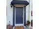 Exterior shot of the front door with a small canopy and visible lighting at 2141 Lake Margaret Dr # 11, Orlando, FL 32806