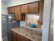 Traditional kitchen with brown cabinets, granite countertops and stainless steel refrigerator at 2141 Lake Margaret Dr # 11, Orlando, FL 32806