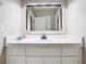 Bathroom vanity features a white countertop, cabinetry, and a stylish mirror at 2614 Parkland Dr, Winter Park, FL 32789