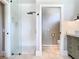 Bright bathroom featuring a glass-enclosed shower with a rain shower head and modern fixtures at 2614 Parkland Dr, Winter Park, FL 32789