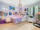 Charming bedroom featuring unique decor, a cozy bed, and a whimsical hanging chair at 2614 Parkland Dr, Winter Park, FL 32789