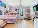 Inviting bedroom with playful decor, a comfortable bed, and a unique hanging chair, perfect for relaxation at 2614 Parkland Dr, Winter Park, FL 32789