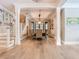 Spacious dining room with hardwood floors, natural light, and staircase for seamless entertaining at 2614 Parkland Dr, Winter Park, FL 32789
