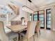 Bright dining area with an elegant chandelier, a bench, and access to the outdoors at 2614 Parkland Dr, Winter Park, FL 32789