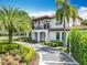 Charming two-story home showcasing a tile roof, balcony, manicured landscaping, and a stone paver driveway at 2614 Parkland Dr, Winter Park, FL 32789