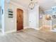 Elegant foyer boasts hardwood floors, stylish light fixture, and a unique wood front door for a grand entrance at 2614 Parkland Dr, Winter Park, FL 32789